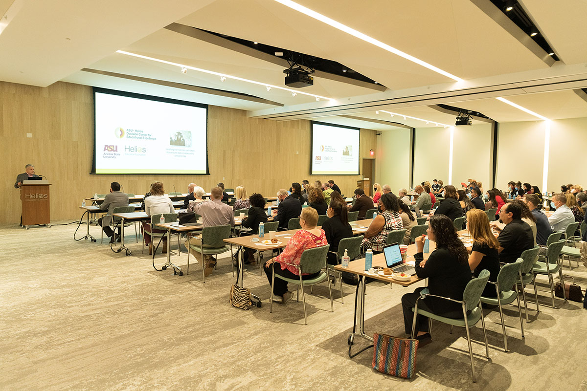 Helios DFCE Event attendees looking at 2 large projection screens